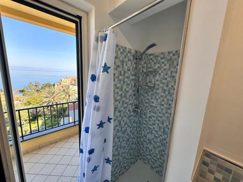 a bathroom with a shower with a view of the ocean at Villa sul tramonto in Castel di Tusa