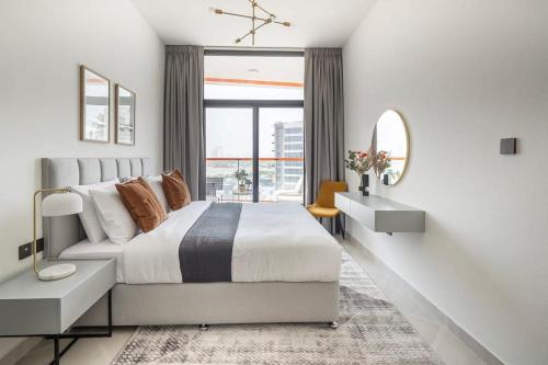 a bedroom with a large bed and a large window at Frank Porter - Binghatti Avenue in Dubai