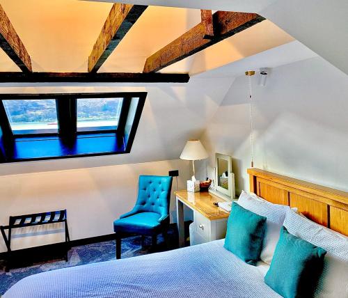 a bedroom with a bed and a desk and a chair at Ardlinnhe Bed & Breakfast in Fort William