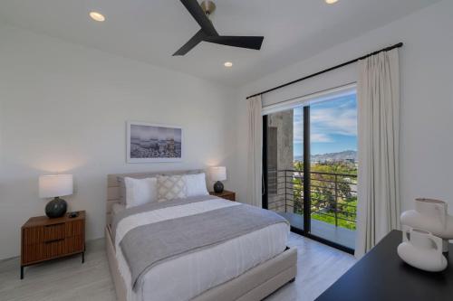 a bedroom with a bed and a sliding glass door at Spacious New 3BR Condo at Tramonti plus Resort Access in Cabo San Lucas