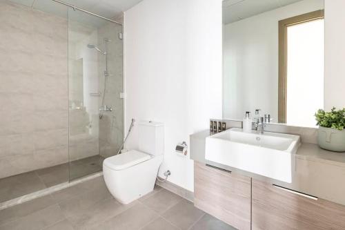 a bathroom with a toilet and a sink and a shower at Frank Porter - Bloom Tower in Dubai