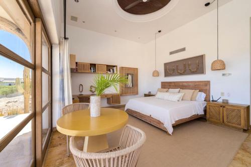a bedroom with a bed and a table at Casa Blue Sea at Cabo del Sol with Ocean Views in Cabo San Lucas