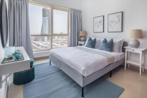 a bedroom with a bed and a large window at Frank Porter - Icon Tower 1 in Dubai