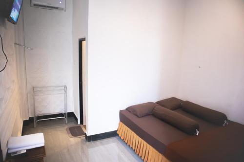 une chambre avec un canapé dans l'angle d'une pièce dans l'établissement KAZAIN HOTEL, à Timuran