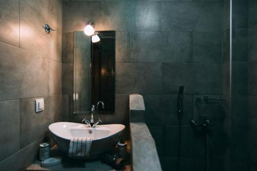 a bathroom with a sink and a shower at Axiokersa Suites in Samothraki