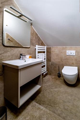 a bathroom with a sink and a toilet at Relax Hotel Stork in Lednice