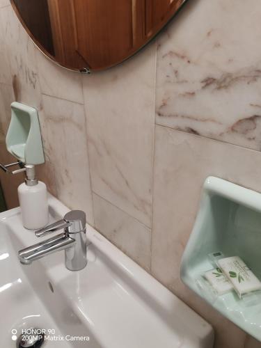 a bathroom with a white sink and a mirror at La Dimora del Conte in Pescara
