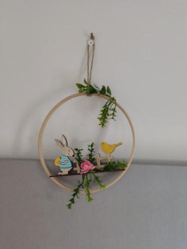 a round wreath with animals on it hanging on a wall at O POSTIGO in Praia da Vitória