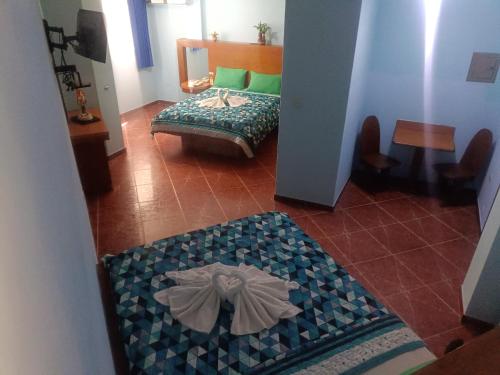 Hotel El Ceibo tesisinde bir odada yatak veya yataklar