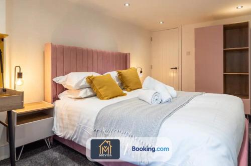 a bedroom with a large white bed with yellow pillows at 3 Bed Apartment By Movida Property Group Short Lets & Serviced Accommodation Harrogate in Harrogate