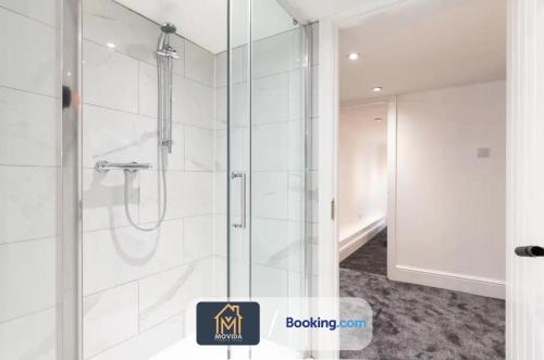 a shower with a glass door in a bathroom at 3 Bed Apartment By Movida Property Group Short Lets & Serviced Accommodation Harrogate in Harrogate
