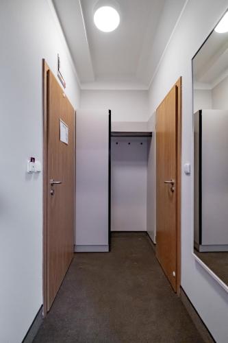 an empty hallway with two doors and a mirror at Relax Hotel Stork in Lednice