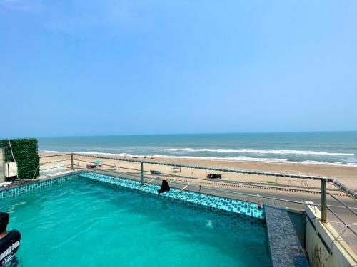 a swimming pool with the beach in the background at Hotel TBS - all-rooms-sea-view, Swimming-pool, fully-air-conditioned-hotel with-lift-and-parking-facility breakfast-included in Puri