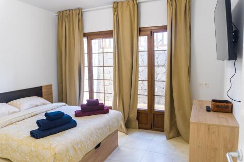 a bedroom with a bed with blue towels on it at CASA PARI in Playa Blanca