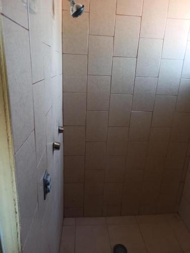 a bathroom with a shower with a tile floor at oaxaca in Oaxaca City