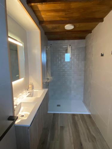 a bathroom with a shower and a sink and a mirror at Tranvía Beach House in Chipiona