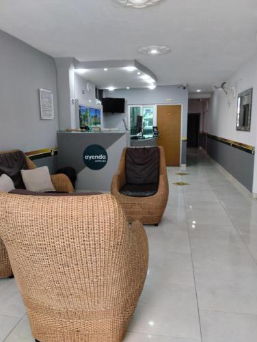 a lobby with two couches and chairs in a store at Ayenda Zhena in Cúcuta