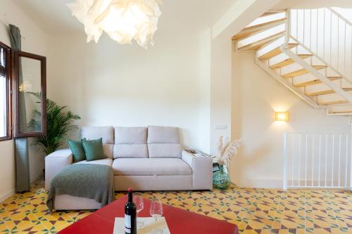 a living room with a couch and a staircase at La Casita del Malecón in Murcia