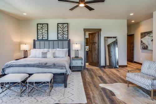 a bedroom with a large bed and two chairs at LUXURY SKI-IN-OUT Mid-Mountain Game Room Hot Tub in Whitefish