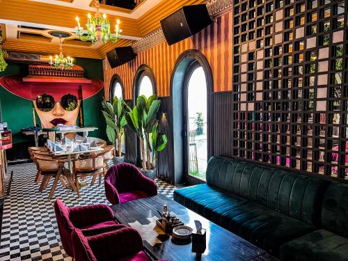 a living room with a couch and a table at DYORE House by Bharat Mahal Palace in Jaipur