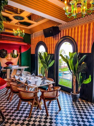 a restaurant with a table and chairs and a giant head at DYORE House by Bharat Mahal Palace in Jaipur