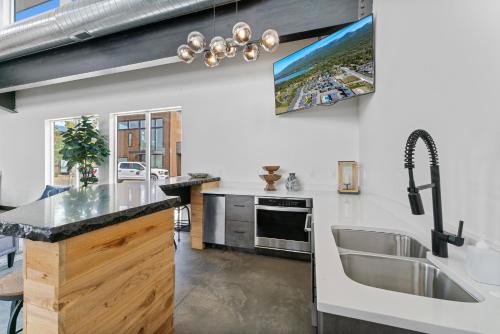 a kitchen with a sink and a counter top at Luxury Amenities with a Central Location to Downtown and Whitefish Mountain Resort in Whitefish