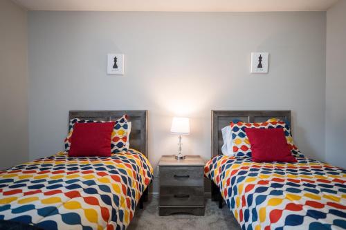two beds sitting next to each other in a room at The Perfect Stay - Your Relaxing Getaway in Valdosta