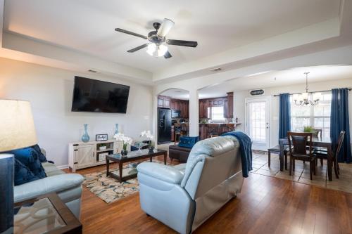 a living room with a couch and a ceiling fan at The Perfect Stay - Your Relaxing Getaway in Valdosta