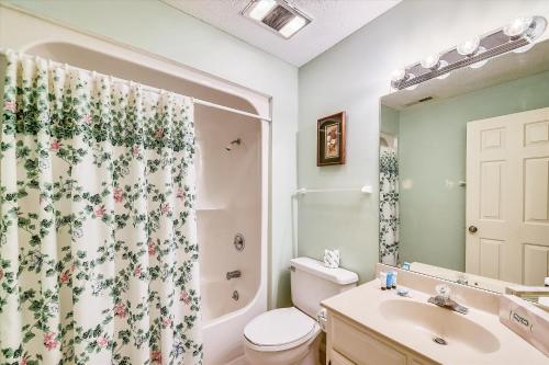 a bathroom with a toilet and a shower curtain at Beachwalk 110 in Hilton Head Island