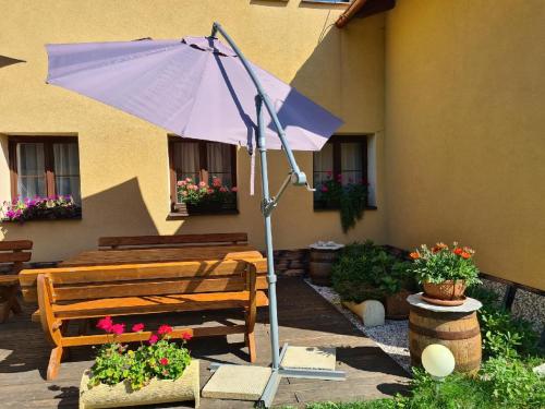 a purple umbrella in front of a building at Rezidence Lipka in Králíky