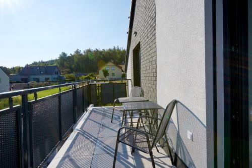 a balcony with two chairs and a table on it at Penzion Kunc - Ubytování v soukromí - Borová 607, Příbram - Střední Čechy in Příbram