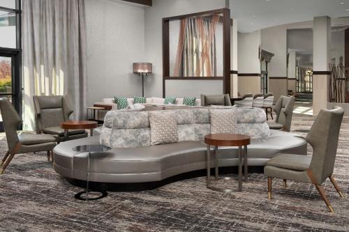 a living room with a couch and chairs at Embassy Suites Springfield in Springfield