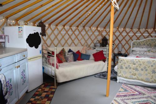 a room with a bed in a yurt at The Yurt in Cornish woods a Glamping experience in Penzance