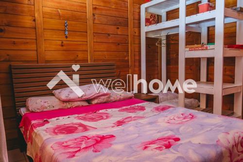 ein Schlafzimmer mit einem Bett mit rosa Blumen drauf in der Unterkunft Casa com área de lazer e vista para as montanhas in Aguas Mornas