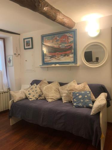 a living room with a couch with pillows on it at CASABARBARA lerici in Lerici