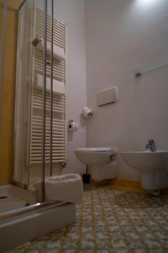 a bathroom with a sink and a toilet and a shower at Relais Villa Al Vento in Incisa in Valdarno