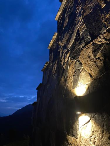 a building on the side of a mountain at night at La Casa de Mario - Gocta in Cocachimba