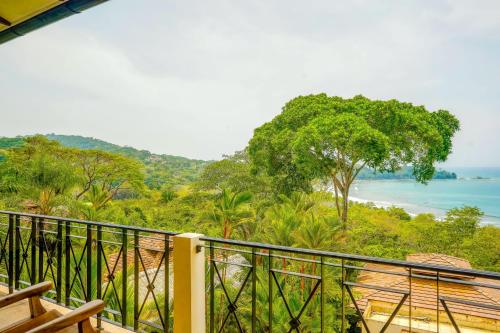 a balcony with a view of the ocean at Canto Del Mar #13 in Dominical