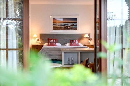 a bedroom with a bed with red pillows on it at Tottam Art & Healthy Garden in Málaga