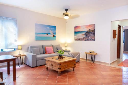 a living room with a couch and a table at Hacienda San Jose Condo by BVR in Playa del Carmen