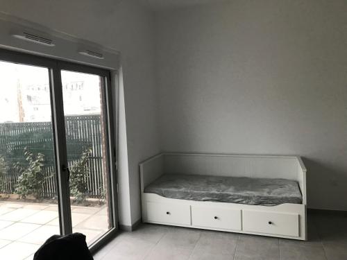 ein kleines Schlafzimmer mit einem Bett und einem Fenster in der Unterkunft Les chti picards in Berck-sur-Mer