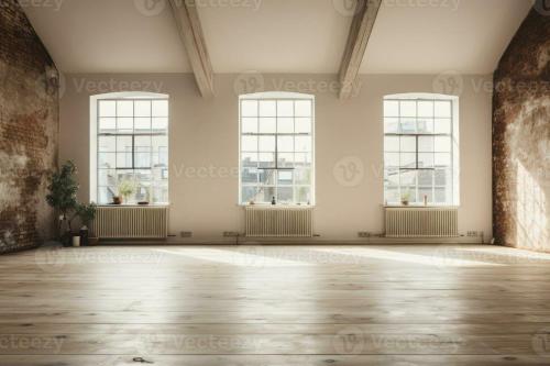 an empty room with three windows and a wooden floor at El Establo in Arequipa