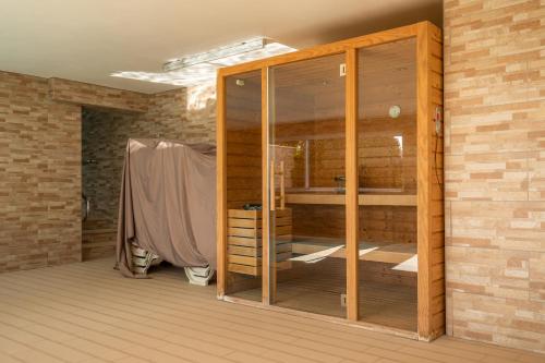 a room with a wooden closet in a brick wall at Casa Chloe Luxury Ocean View Apartment in Lagos