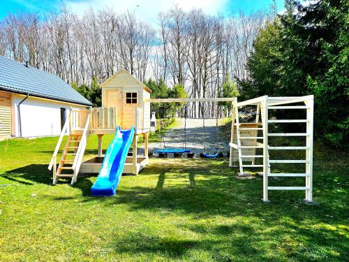 a playground with a slide and a ladder and a slideintend at Bieszczadzka Pauza in Polańczyk