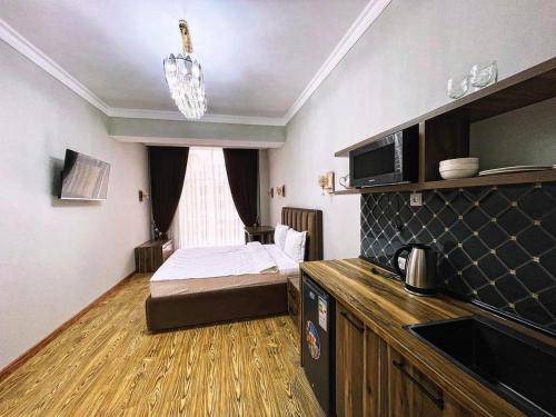 a small room with a bed and a window at Апартаменты рядом с Hilton in Dushanbe