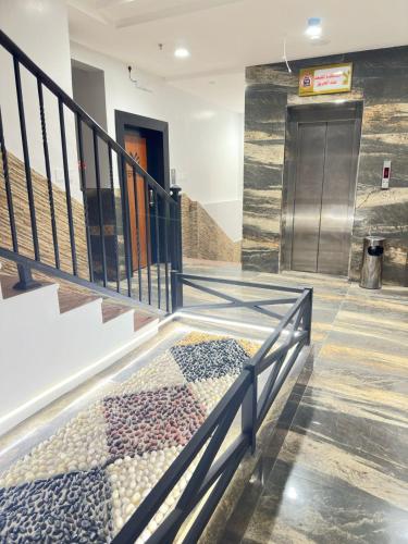a hallway with stairs with a stair railing at فربيون للشقق الفندقية ابها in Abha