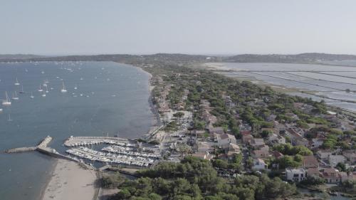 an aerial view of a small town on the beach at Le Hameau Des Pesquiers Ecolodge & Spa, Curio Collection By Hilton in Hyères