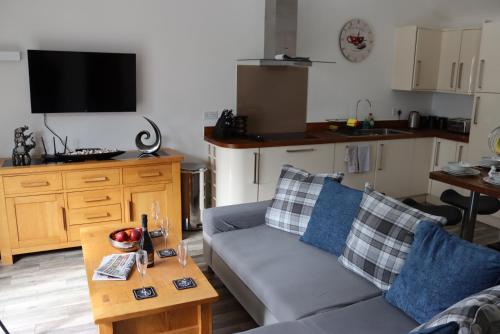 a living room with a couch and a table at Ferndown Holiday Let in Ferndown