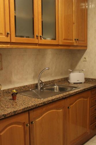 a kitchen counter with a sink and a toaster at House4U Vila Nova in Vila Nova de Gaia