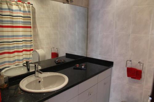 a bathroom with a sink and a mirror at House4U Vila Nova in Vila Nova de Gaia
